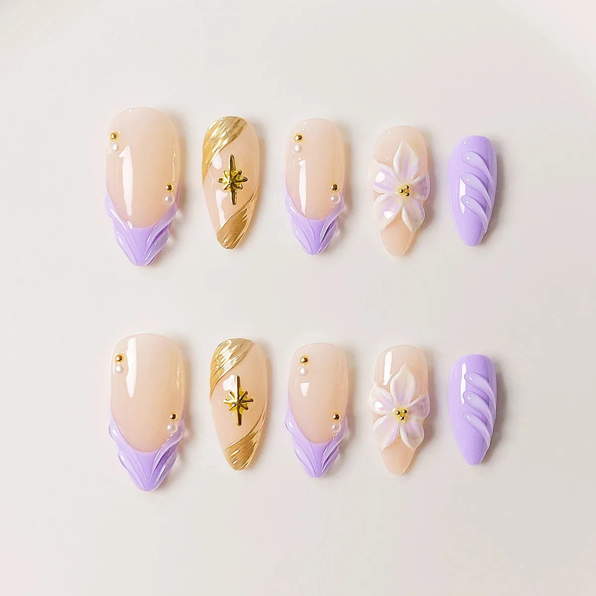 10 handmade almond-shaped press-on nails with purple water ripple design and starburst pattern in a high-end style.