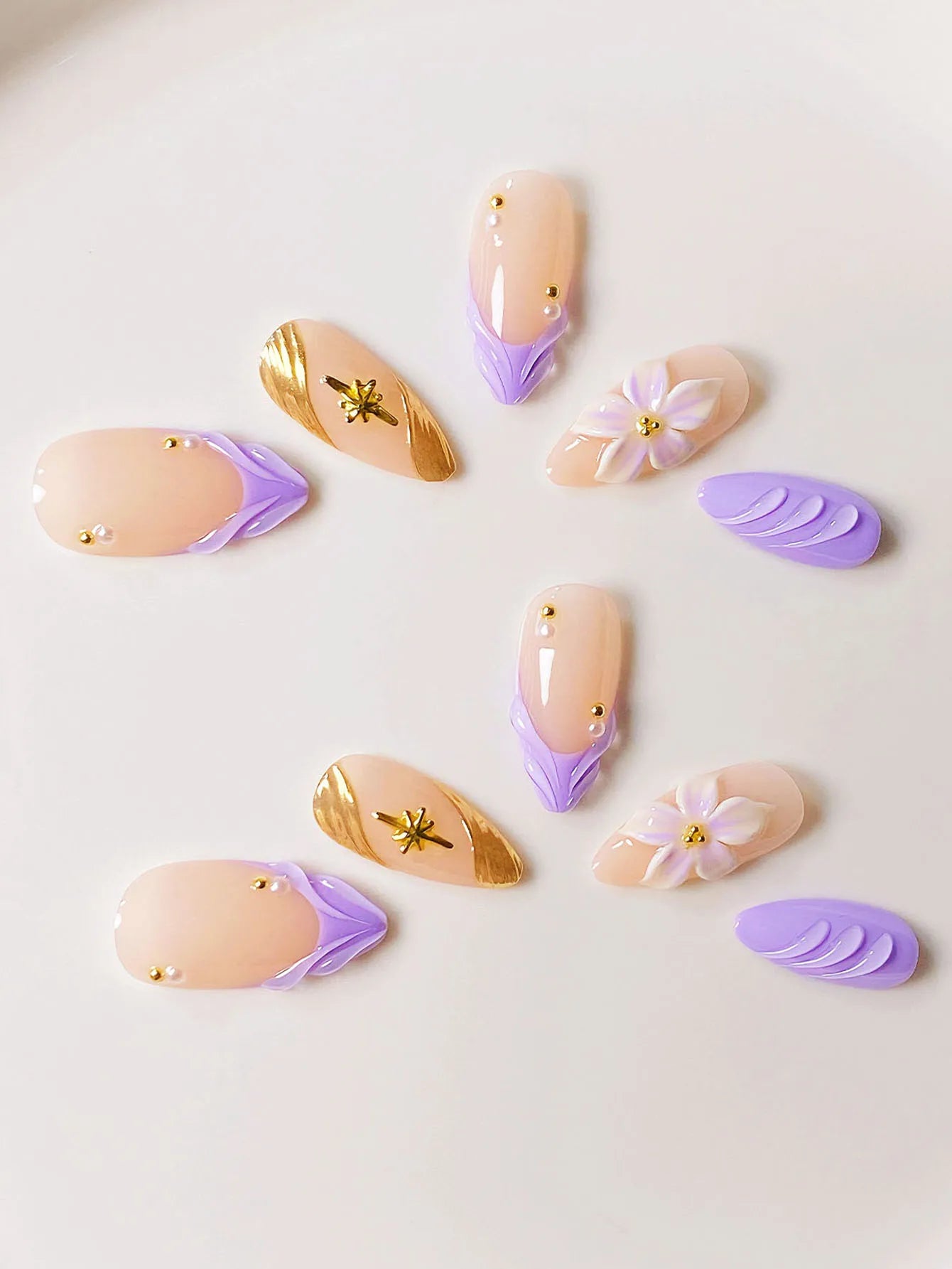 10 handmade almond-shaped press-on nails with purple water ripple design and starburst pattern in a high-end style.